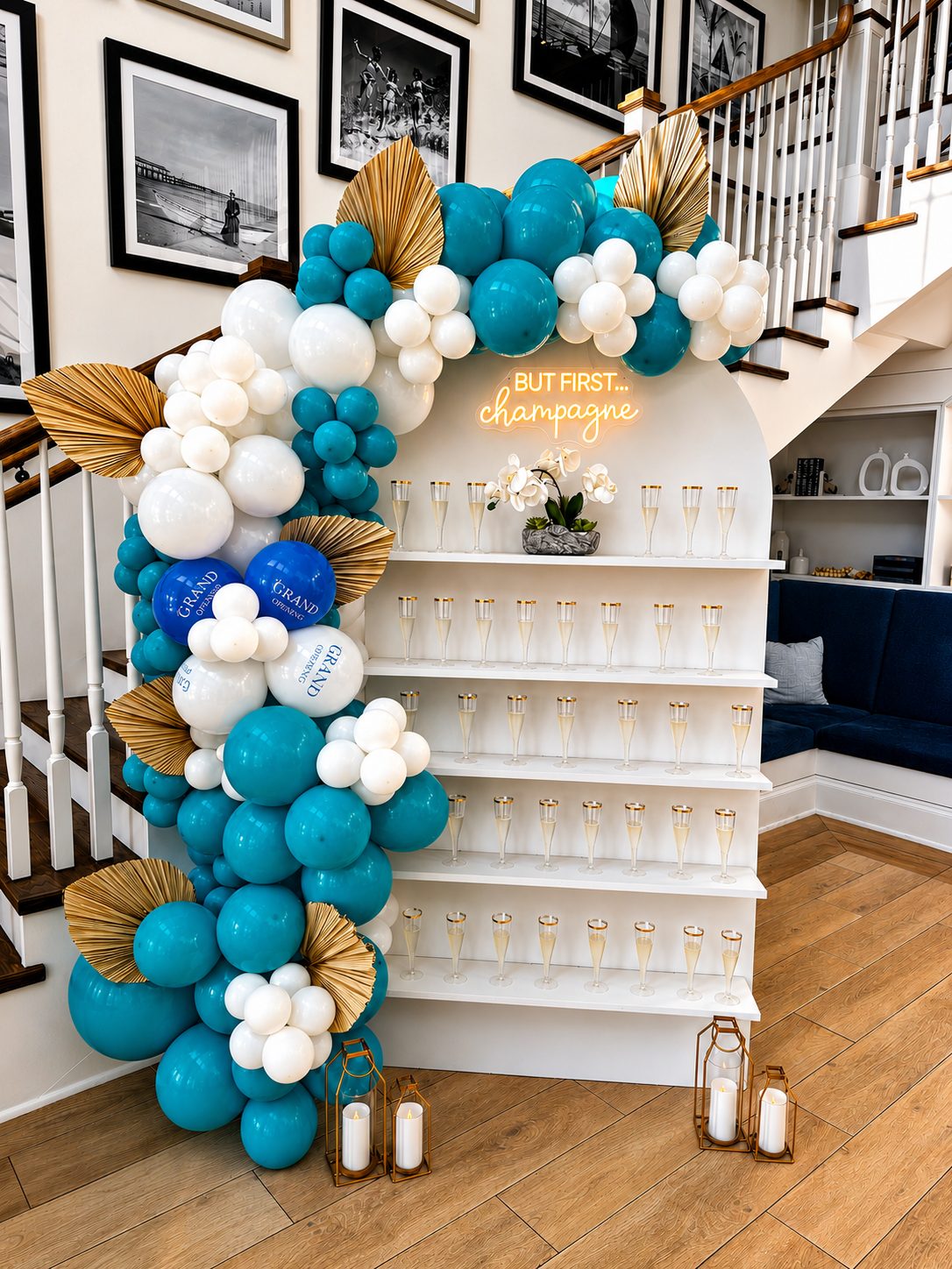 Champagne wall with a teal and gold balloon arch