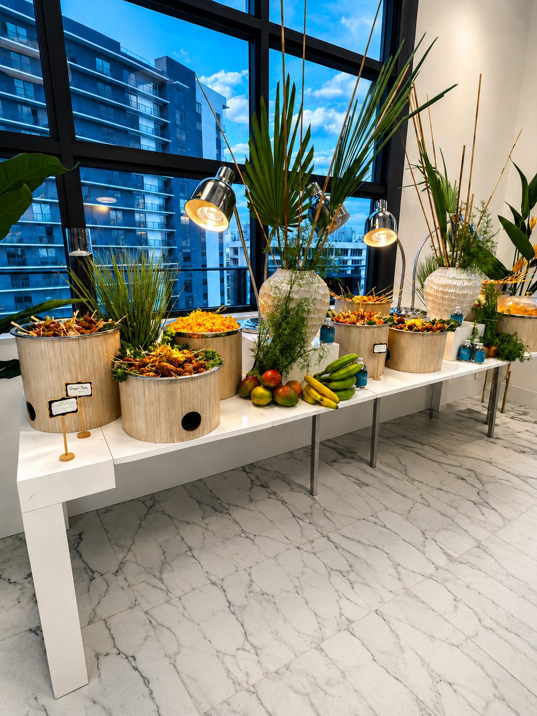 Catering station styled with greenery and warmers