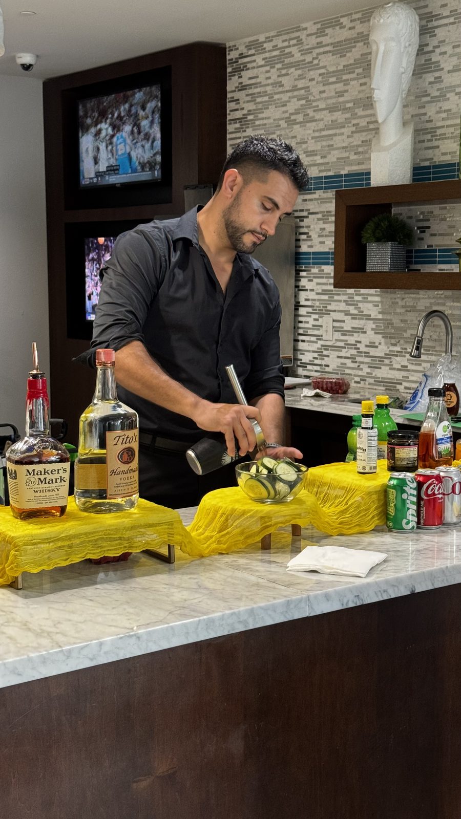A mixologist pouring drinks for residents
