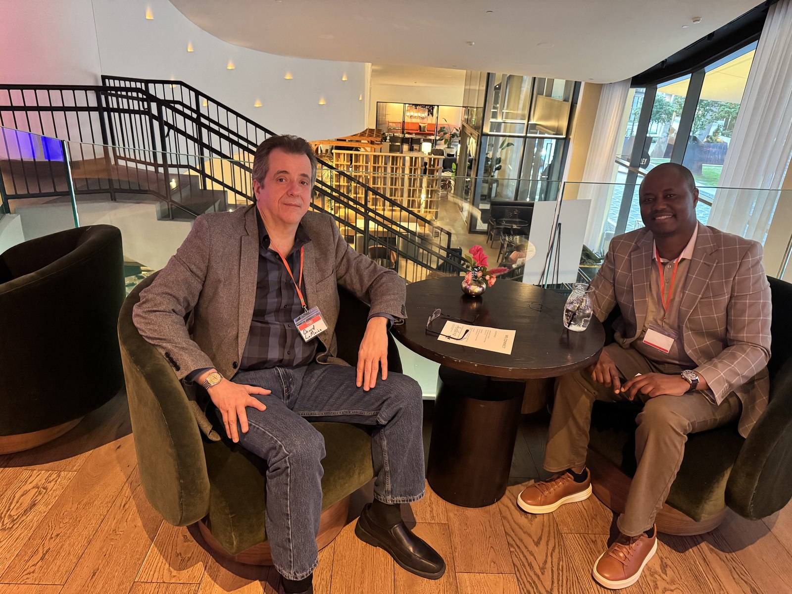 Two professionals in conversation at a networking lounge